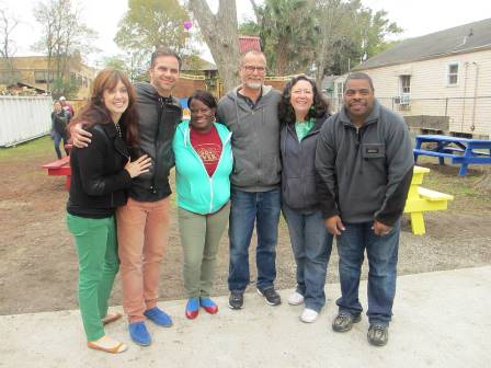 Six people stand together outdoors at an Emerson Orthodontics community event or gathering.