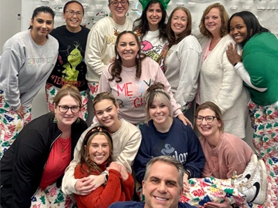 Emerson Orthodontics team members posing together for a group photo in an office setting.