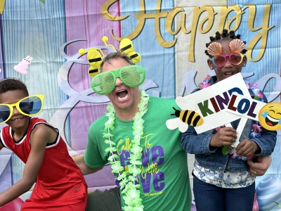 Children in festive costumes celebrate at Emerson Orthodontics' Happy event with bee-themed decorations.